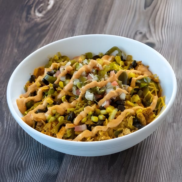 Holy Bowly's Middle Eastern bowl, topped with a creamy sauce, corn, and black beans.